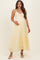 woman wearing a light yellow maternity maxi dress with lace detail and a baby bump visible