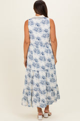 woman wearing a blue and white floral print maternity maxi dress with a tiered design, showing a baby bump from the back