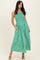 woman wearing a green and white striped maxi dress with smocked bodice and pockets