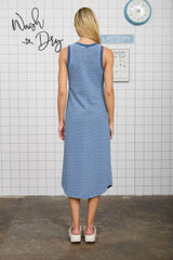 woman wearing a navy and white striped sleeveless maxi dress, showing the back view and styled for casual wear