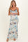 woman wearing a floral printed maternity maxi dress with lace detailing and a visible baby bump