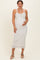 woman wearing a white floral maternity maxi dress with ruffled straps and holding her baby bump