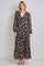 woman wearing a black floral maxi dress with long sleeves and tiered ruffles