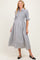 woman wearing a black and white gingham maternity dress with short sleeves and button-down front, showcasing a baby bump