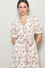 woman wearing a floral print wrap dress with puff sleeves and a v-neckline