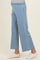 woman wearing light blue maternity wide-leg pants with an elastic waistband and side pockets