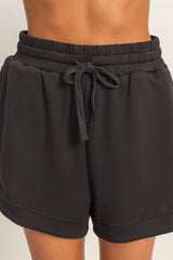 black elastic waist shorts with drawstring detail and relaxed fit