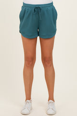 woman wearing a teal maternity shorts with an elastic waistband and drawstring detail