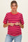 woman wearing a red and blue striped maternity top with short sleeves and a visible baby bump