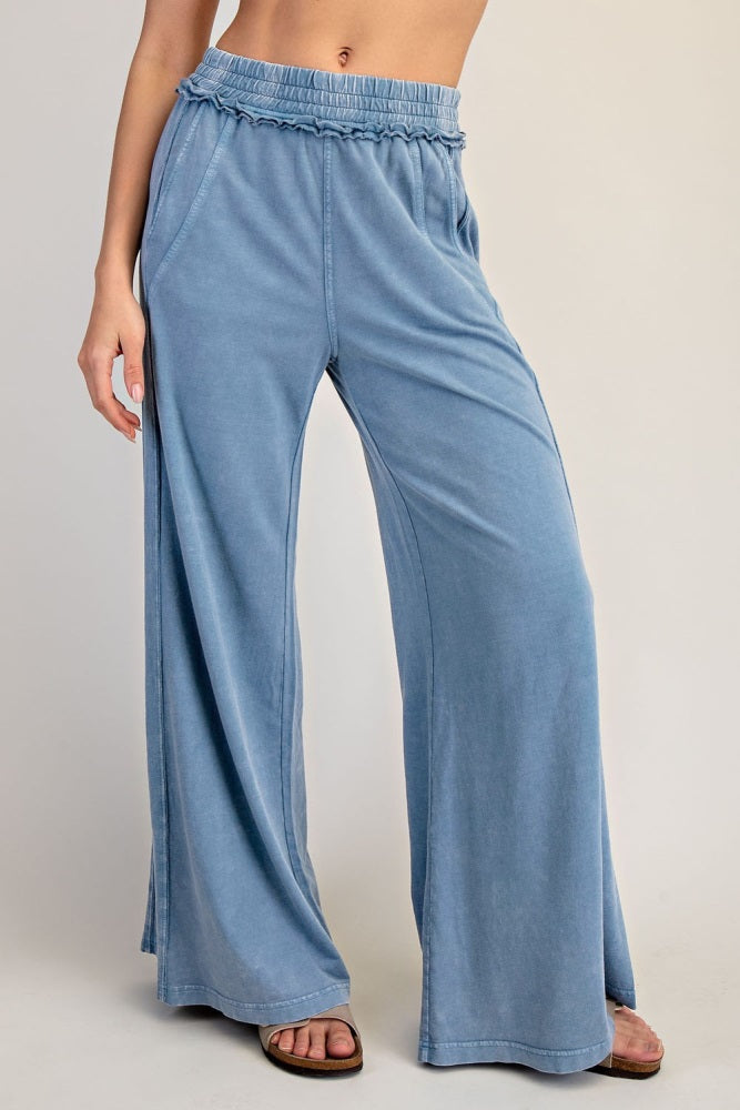 woman wearing light blue wide-leg lounge pants with an elastic waistband and side pockets