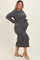 woman wearing a dark gray ribbed maternity dress with a tie waist and a visible baby bump