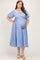 woman wearing a blue floral maternity dress with puff sleeves and a fitted waist, holding her baby bump