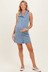 woman wearing a light denim sleeveless maternity dress with a large collar and buttons, holding her baby bump