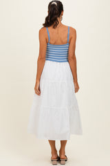 woman wearing a blue and white striped backless maxi dress with a tiered white skirt and a fitted bodice