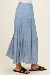 woman wearing a light blue floral maxi skirt with tiered design and a relaxed fit