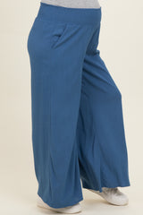 woman wearing a blue wide-leg maternity pant with an elastic waistband and side pockets