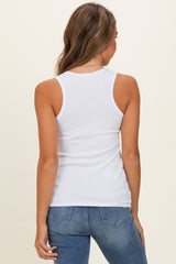 woman wearing a white ribbed tank top and blue jeans, showing the back view of the top