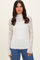 woman wearing a white long sleeve lace top with a high neck and fitted silhouette