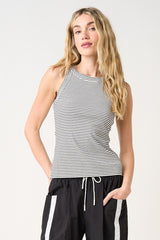 woman wearing a black and white striped tank top with a high neckline and relaxed fit shorts