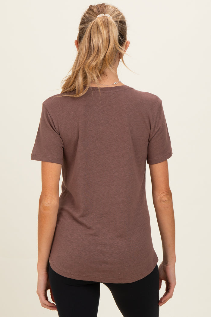 woman wearing a brown short sleeve maternity top viewed from the back