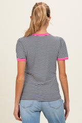 woman wearing a black and white striped maternity top with pink trim on the sleeves and neckline
