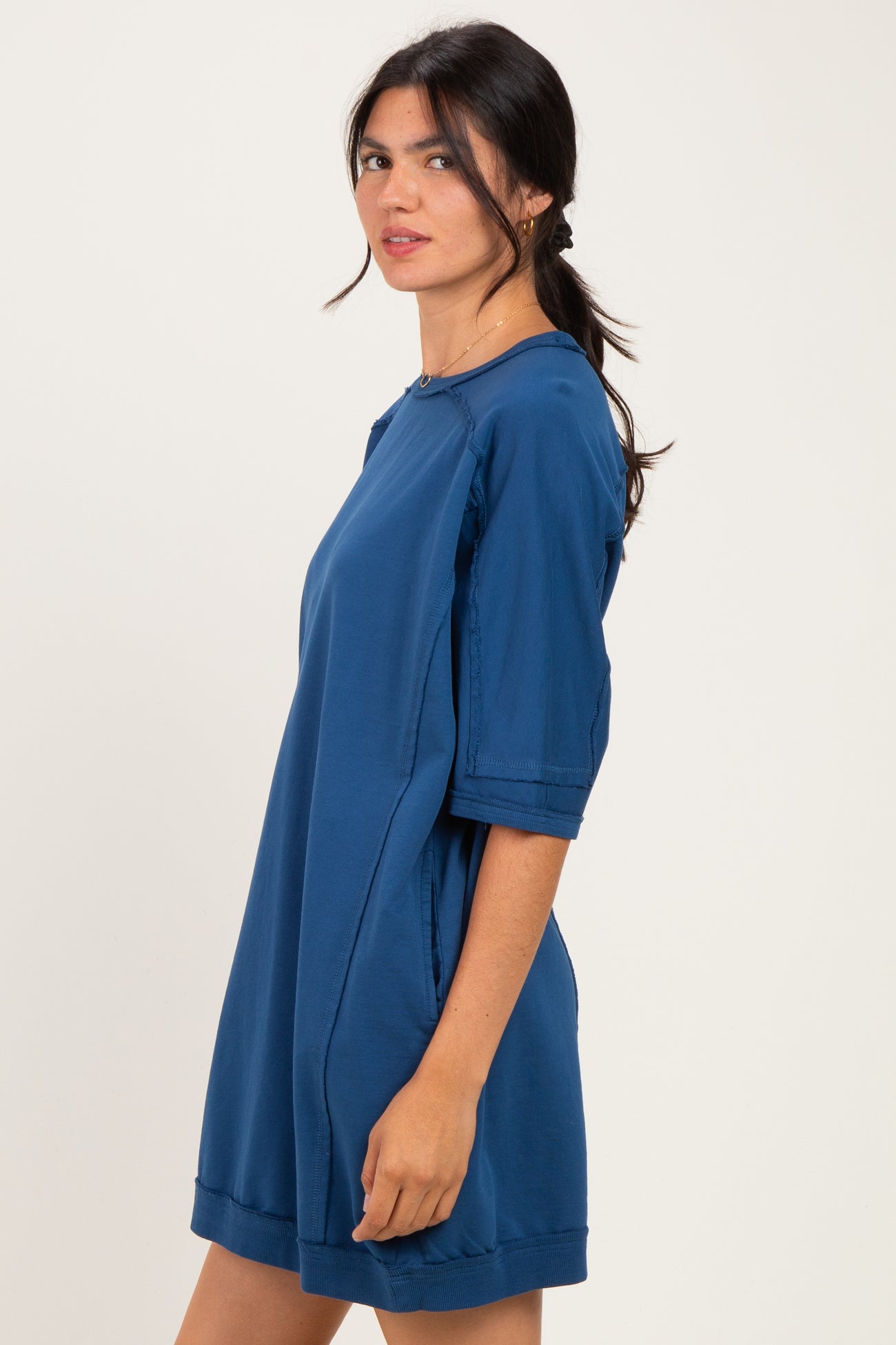 woman wearing a navy blue oversized t-shirt dress with short sleeves and a relaxed fit
