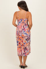 woman wearing a floral print maternity maxi dress with a smocked bodice and spaghetti straps, viewed from the back