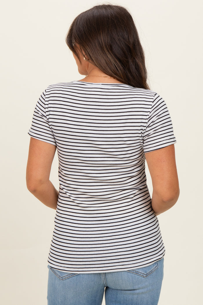woman wearing a striped maternity short sleeve top, viewed from the back, paired with blue jeans