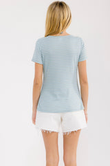 woman wearing a light blue and white striped short sleeve top with a relaxed fit, paired with white denim shorts