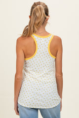 woman wearing a white maternity tank top with yellow floral patterns and yellow trim, showing the back view