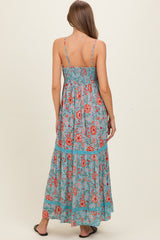 woman wearing a floral print maternity maxi dress with a smocked back and adjustable straps