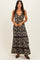 woman wearing a black floral maxi dress with a deep v-neck and cut-out detailing