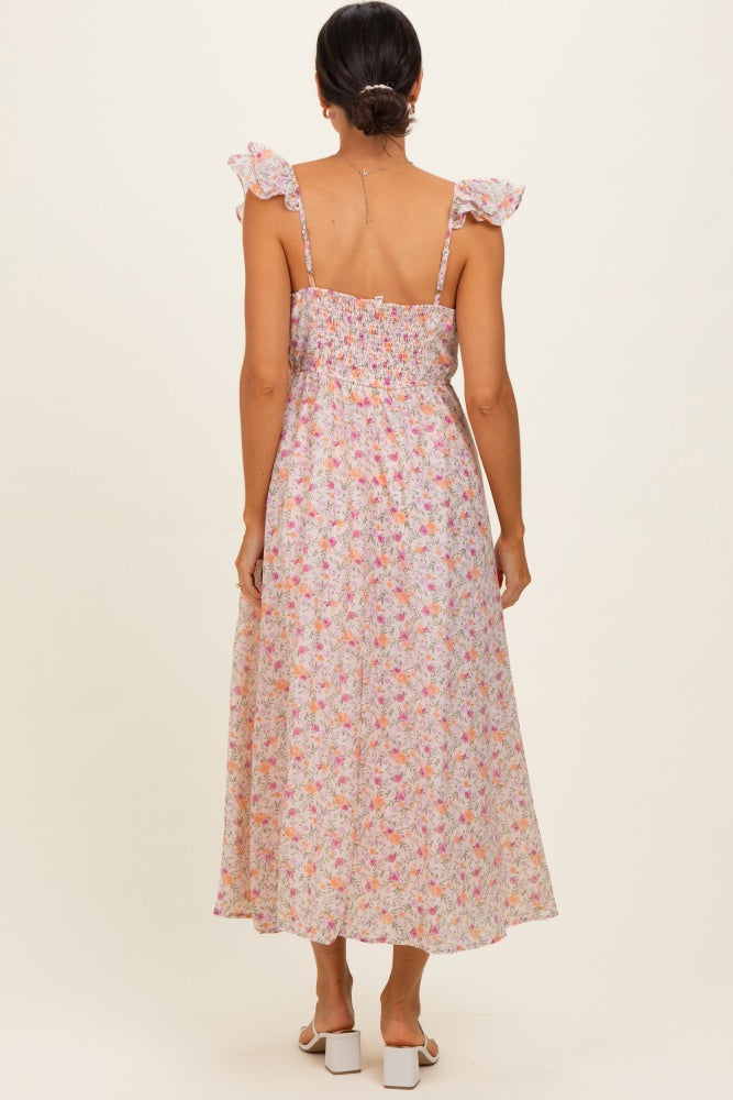 woman wearing a floral maxi dress with ruffled straps and a smocked back detail, viewed from the back