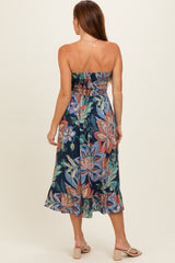 woman wearing a strapless floral midi dress with a fitted bodice and a flared skirt, viewed from the back