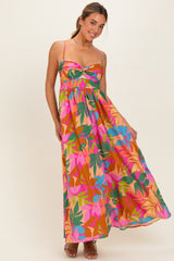 woman wearing a colorful floral maxi dress with a sweetheart neckline and spaghetti straps