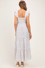 woman wearing a lavender floral maternity maxi dress with ruffled sleeves and square back detail