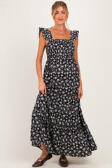 woman wearing a black floral maternity maxi dress with ruffled sleeves and a square neckline