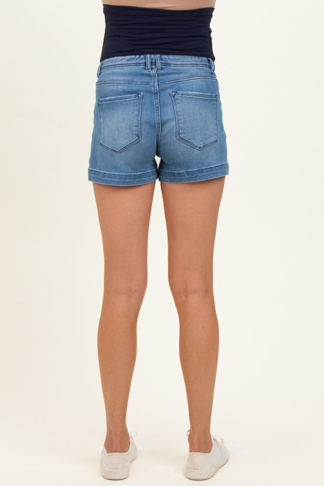 woman wearing light blue maternity denim shorts, showing the back view with a fitted waistband