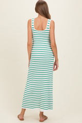 woman wearing a striped teal and white maternity maxi dress with a scoop back and a fitted silhouette