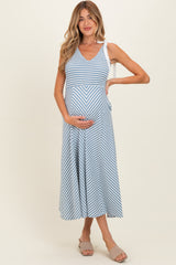 woman wearing a blue and white striped maternity dress with a v-neck and holding her baby bump