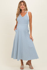 woman wearing a light blue and white striped maternity dress with a v-neck and shoulder ties, featuring pockets