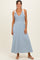 woman wearing a blue and white striped maxi dress with tie shoulder straps and a fitted bodice