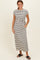 woman wearing a striped maxi dress with short sleeves and a side tie, posed with hands in pockets