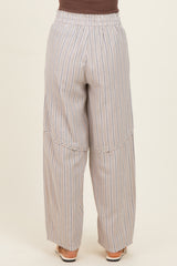 woman wearing light gray wide-leg striped pants with an elastic waistband, viewed from the back