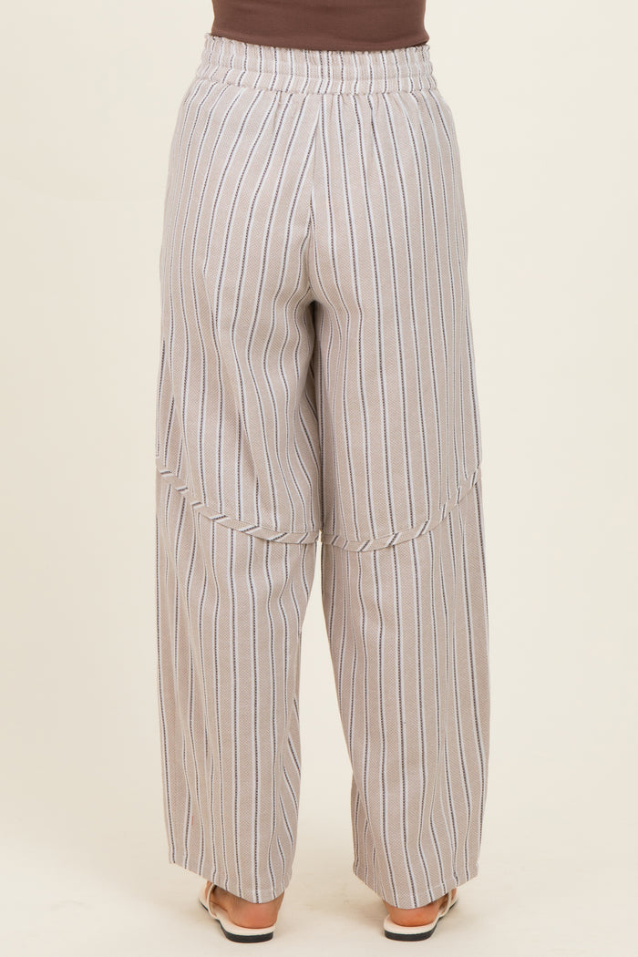 woman wearing light gray wide-leg striped pants with an elastic waistband, viewed from the back