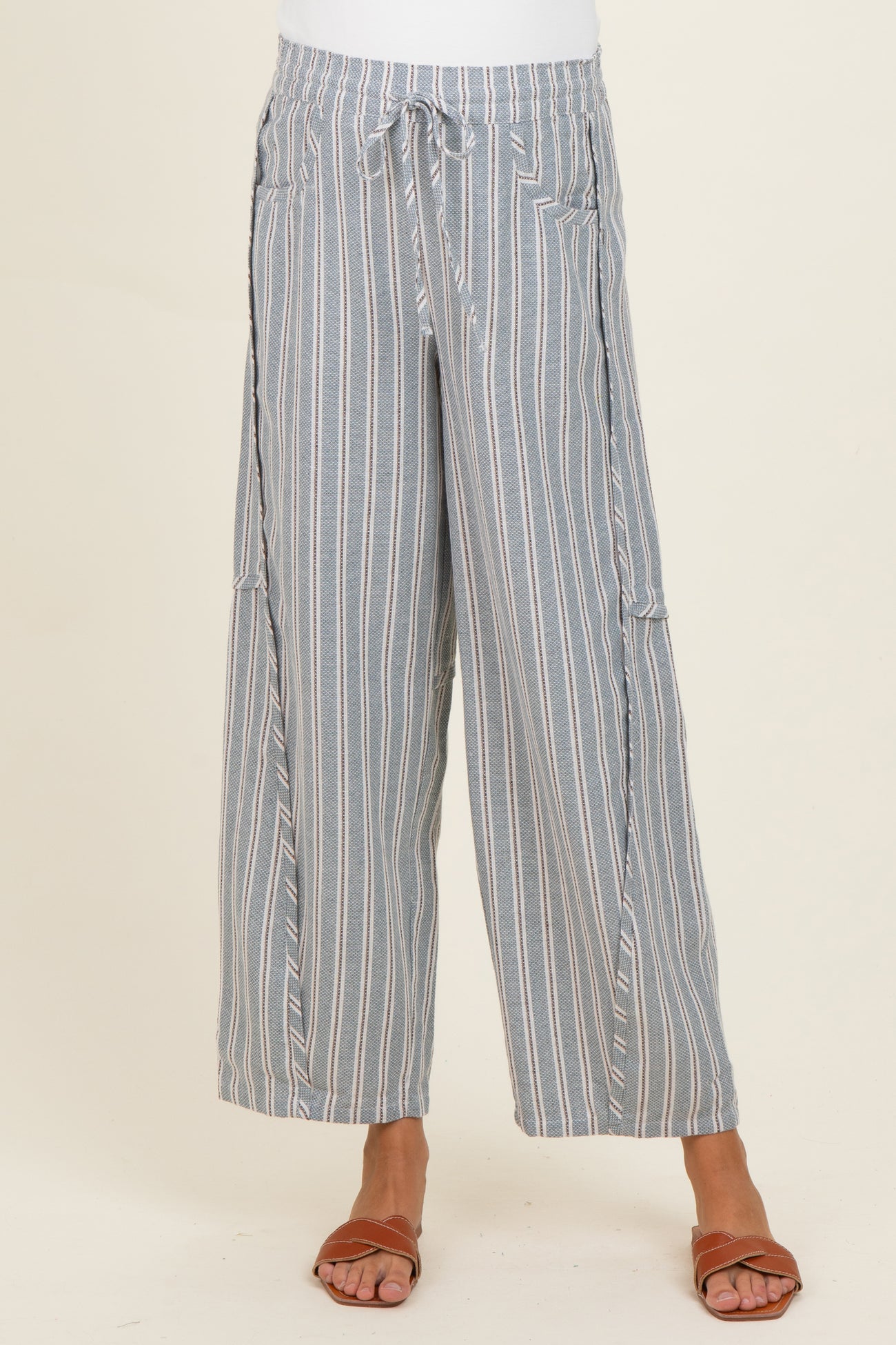woman wearing blue and white striped maternity wide-leg pants with a drawstring waist and pockets