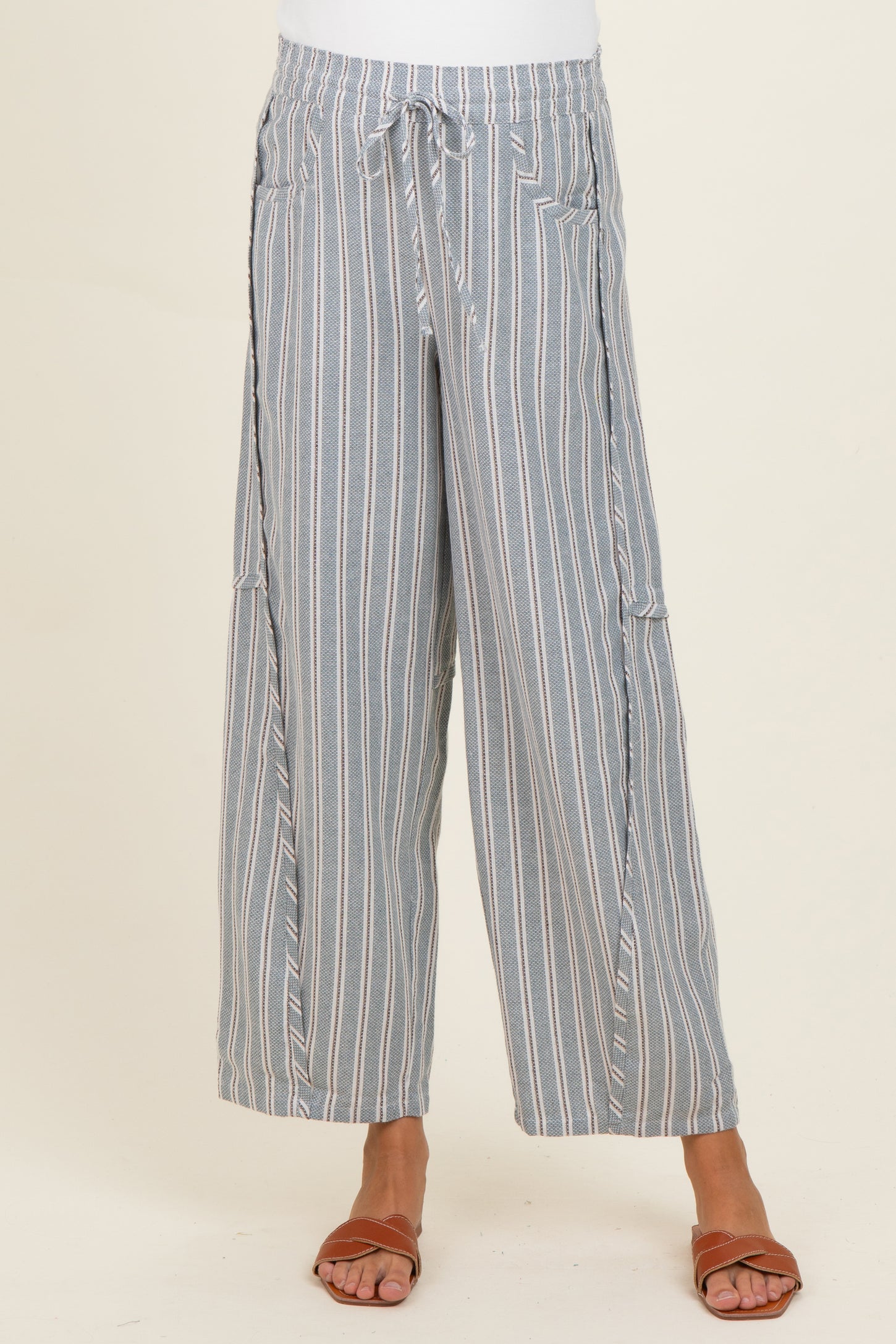 woman wearing blue and white striped maternity wide-leg pants with a drawstring waist and pockets