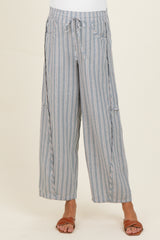 woman wearing blue and white striped maternity wide-leg pants with a drawstring waist and pockets