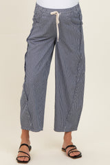 woman wearing navy and white striped maternity pants with a drawstring waist and relaxed fit