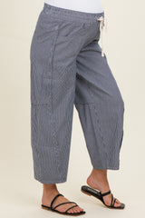 woman wearing navy and white striped maternity palazzo pants with a drawstring waist and side pockets